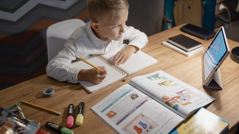boy-in-white-long-sleeve-jumper-reading